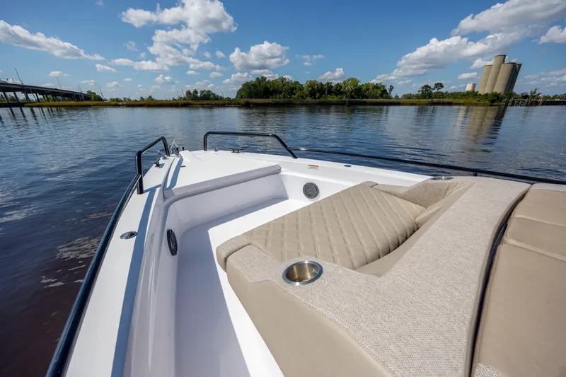  Yacht Photos Pics 2024 Axopar 37 XC boat on calm water, featuring luxurious seating and clear blue skies.