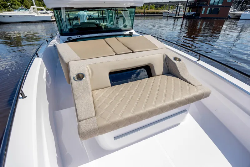  Yacht Photos Pics 2024 Axopar 37 XC boat with luxurious seating and sleek design on the water.