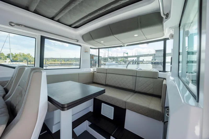  Yacht Photos Pics Luxurious interior of 2024 Axopar 37 XC boat with spacious seating and panoramic windows.