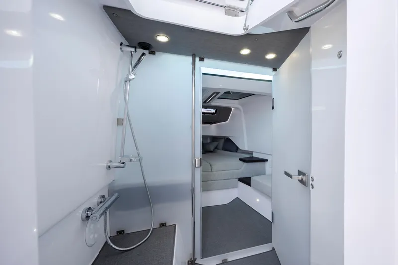  Yacht Photos Pics Luxurious interior of 2024 Axopar 37 XC, featuring modern shower and cozy cabin.