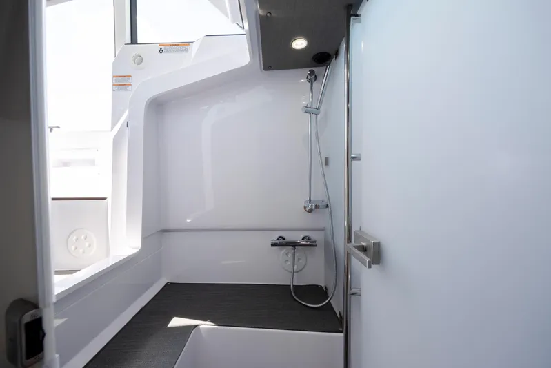  Yacht Photos Pics 2024 Axopar 37 XC boat interior shower with modern fixtures and sleek design.