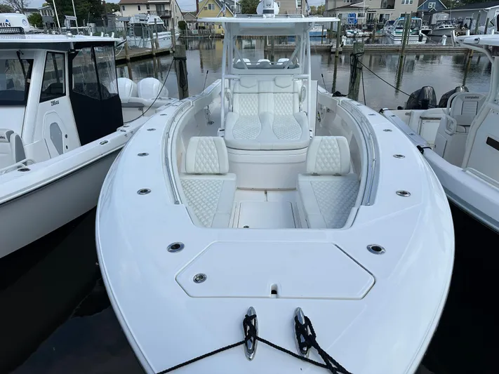  Yacht Photos Pics 2021 Invincible 390 Open CC boat docked, featuring spacious seating and sleek design.