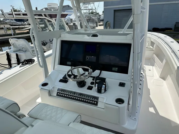  Yacht Photos Pics 2021 Invincible 390 Open CC boat cockpit with modern controls and dual screens.