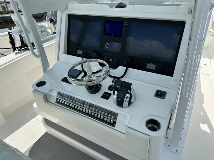  Yacht Photos Pics 2021 Invincible 390 Open CC boat console with steering wheel and control panel.