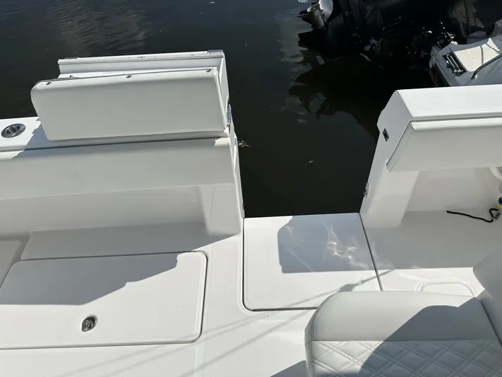  Yacht Photos Pics 2021 Invincible 390 Open CC boat interior with white seating and deck, near water.