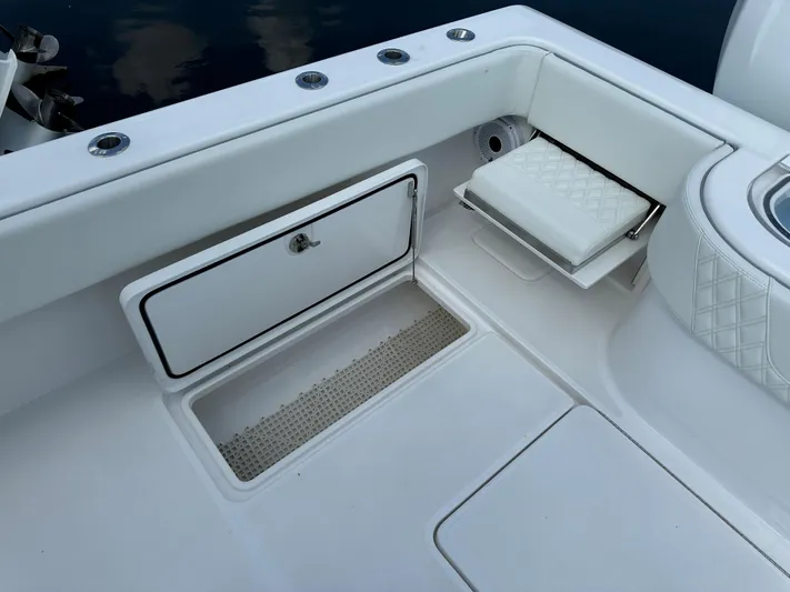  Yacht Photos Pics 2021 Invincible 390 Open CC boat interior with storage compartment and cushioned seating.