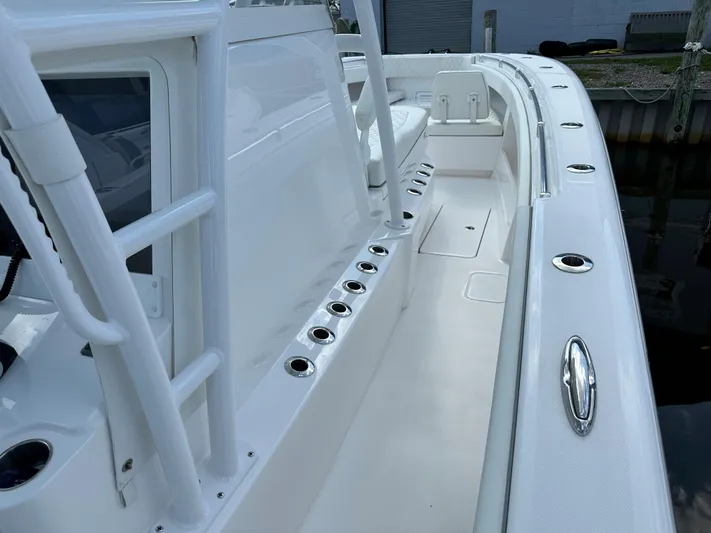  Yacht Photos Pics 2021 Invincible 390 Open CC boat interior with rod holders and seating.