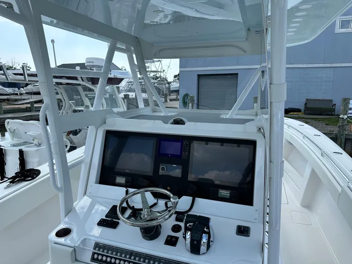  Yacht Photos Pics 2021 Invincible 390 Open CC boat dashboard with dual screens and steering wheel.