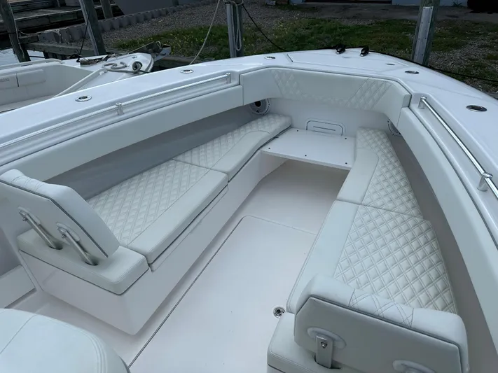  Yacht Photos Pics 2021 Invincible 390 Open CC boat with white cushioned seating and diamond stitching.