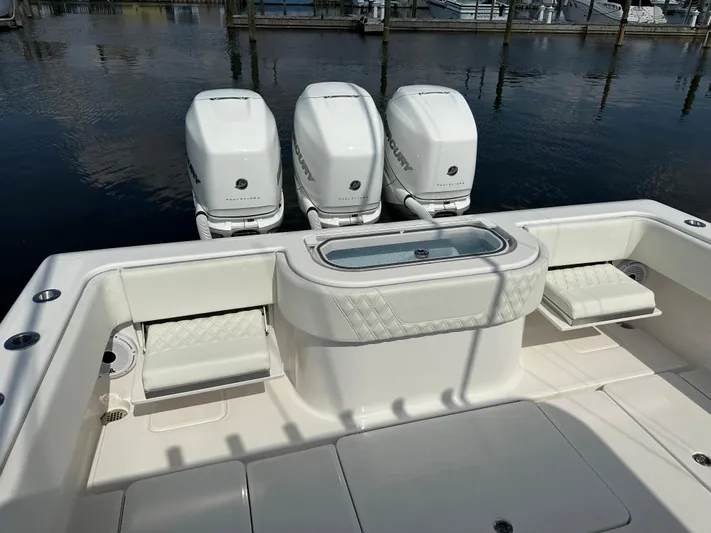  Yacht Photos Pics 2021 Invincible 390 Open CC boat with triple outboard engines, docked at marina.