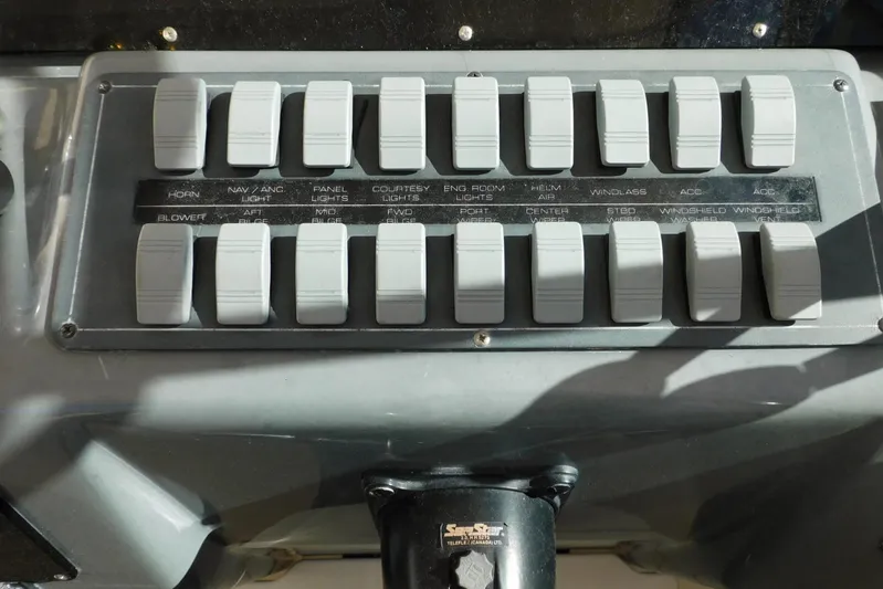 Squall Line Yacht Photos Pics Control panel of a 1995 Tiara Yachts 3500 Express with labeled switches.