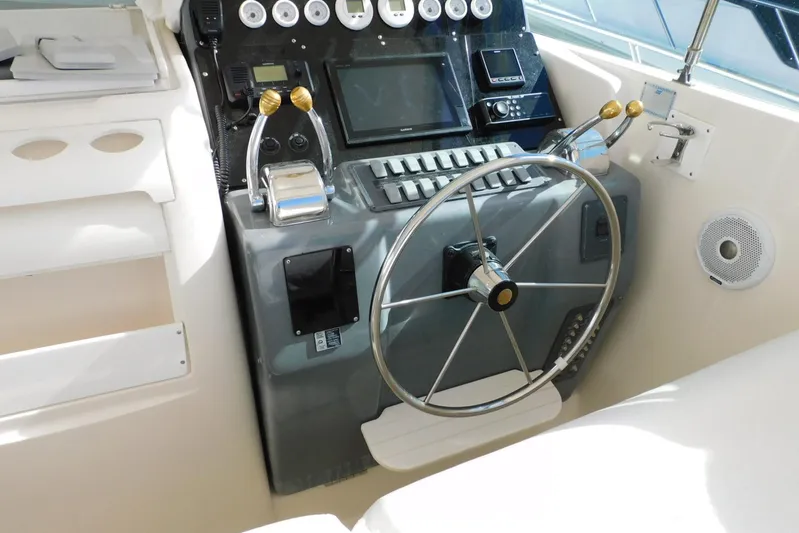 Squall Line Yacht Photos Pics 1995 Tiara Yachts 3500 Express helm with steering wheel and control panel.