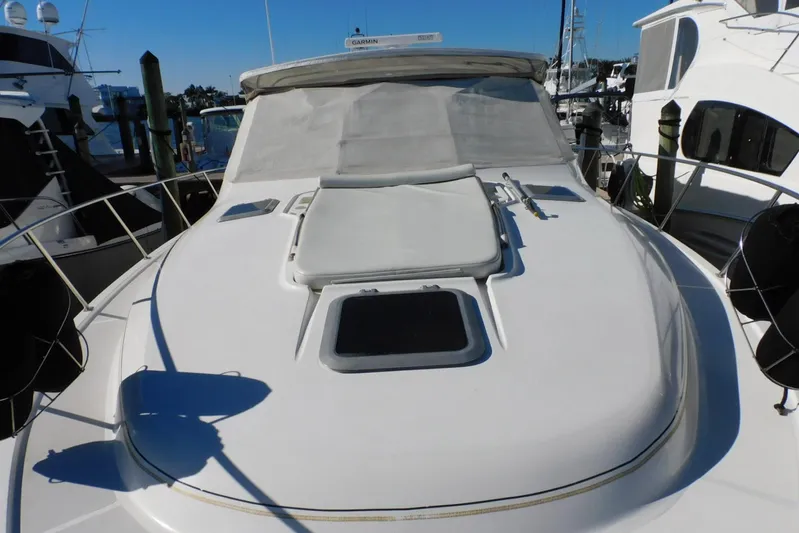 Squall Line Yacht Photos Pics 1995 Tiara Yachts 3500 Express boat deck with sun pad and hatch, docked at marina.