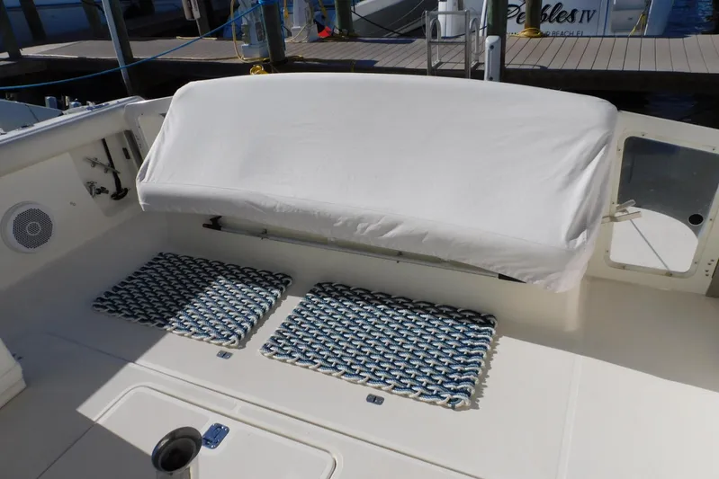 Squall Line Yacht Photos Pics 1995 Tiara Yachts 3500 Express boat deck with covered seating and patterned mats.