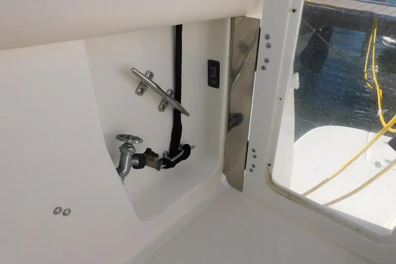 Squall Line Yacht Photos Pics 1995 Tiara Yachts 3500 Express interior detail with cleat and water valve.