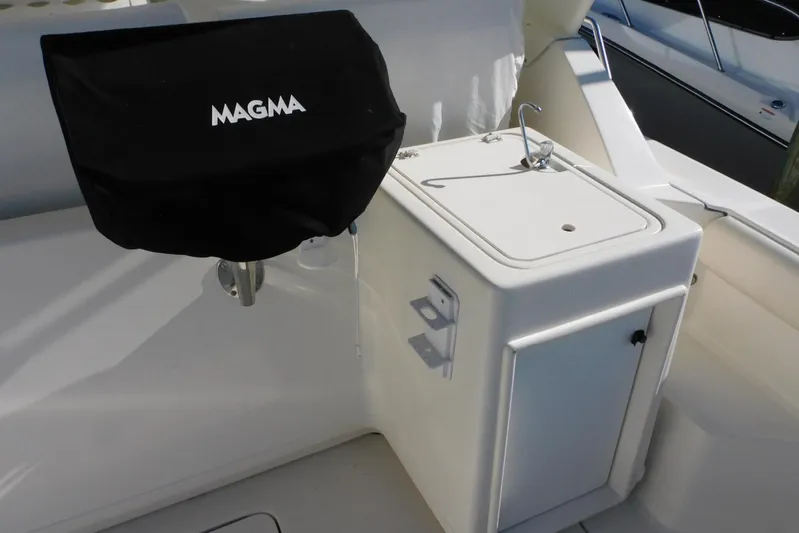 Squall Line Yacht Photos Pics Outdoor kitchen area on a 1995 Tiara Yachts 3500 Express with Magma grill cover.