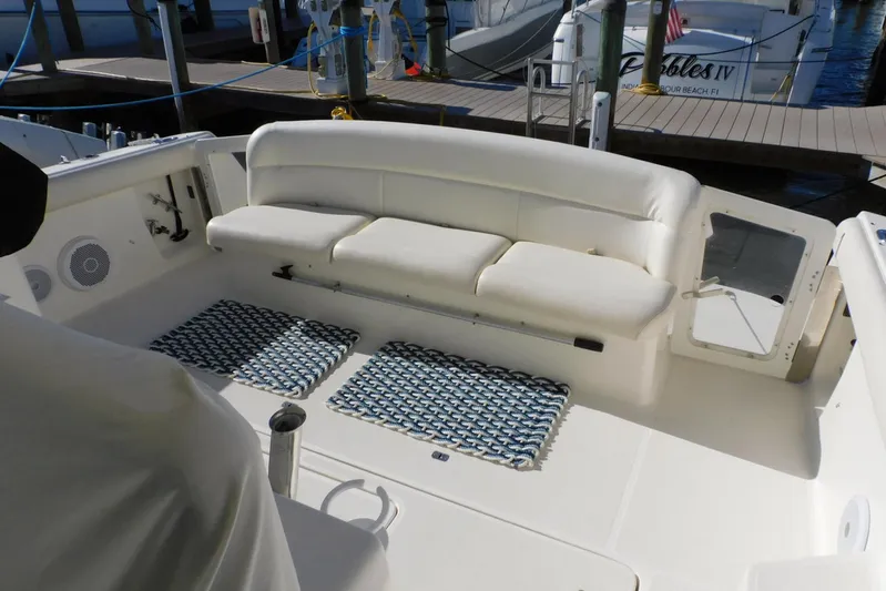 Squall Line Yacht Photos Pics 1995 Tiara Yachts 3500 Express interior with white seating and patterned mats.