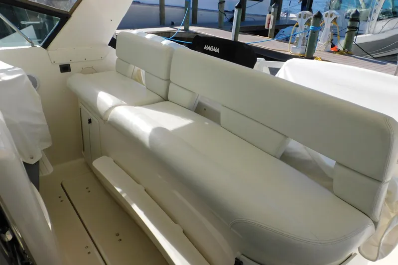 Squall Line Yacht Photos Pics 1995 Tiara Yachts 3500 Express interior seating, featuring white cushioned benches.