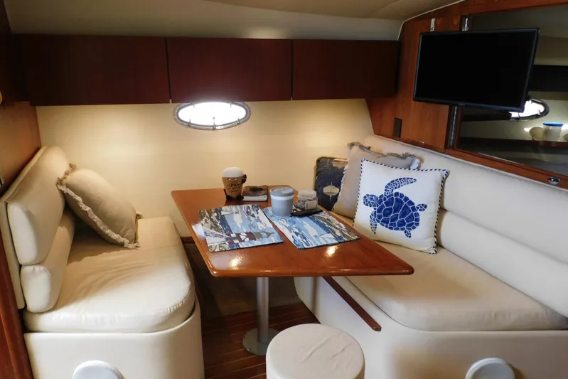 Squall Line Yacht Photos Pics Interior of 1995 Tiara Yachts 3500 Express with cozy dining area and nautical decor.