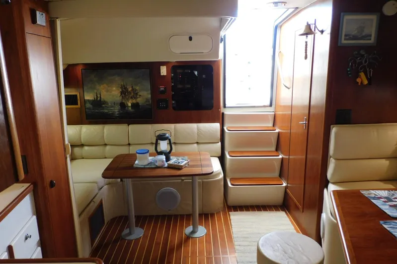 Squall Line Yacht Photos Pics Interior of a 1995 Tiara Yachts 3500 Express with wood accents and cozy seating.