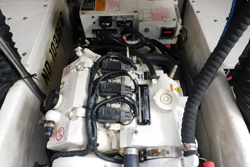 Squall Line Yacht Photos Pics Engine compartment of a 1995 Tiara Yachts 3500 Express, showcasing mechanical components and wiring.