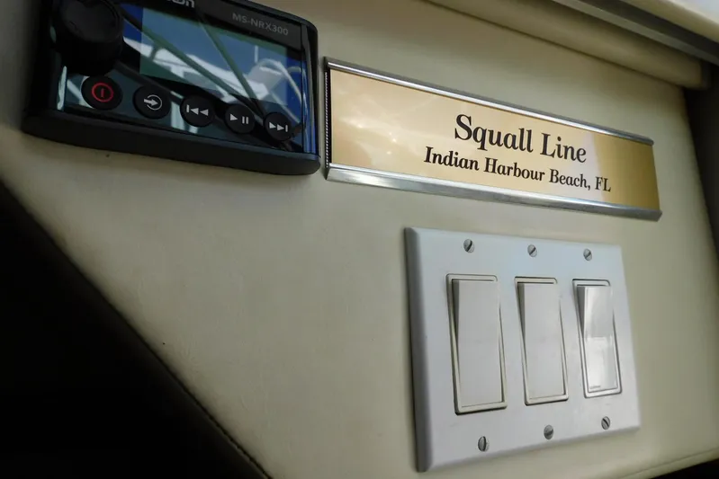 Squall Line Yacht Photos Pics 1995 Tiara Yachts 3500 Express interior with control panel and "Squall Line" nameplate.