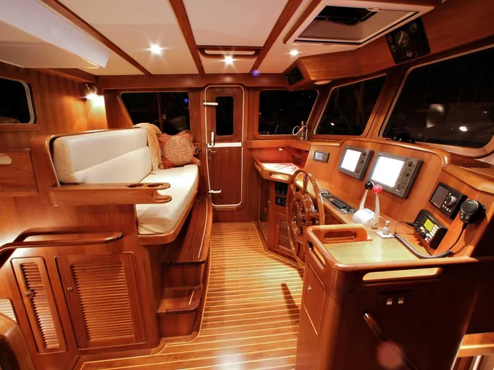  Yacht Photos Pics Luxurious 2026 Selene 46 yacht interior with wooden finish and modern navigation equipment.