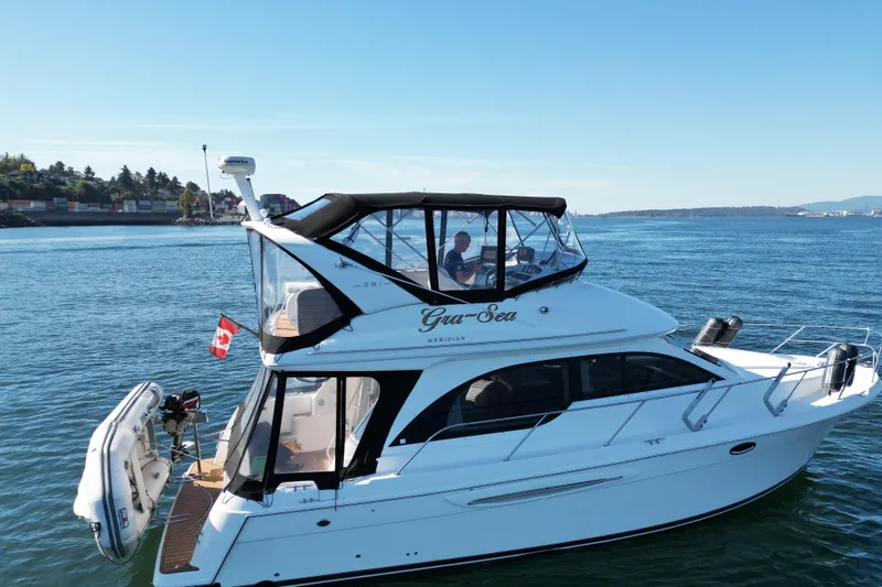 Gra-sea Yacht Photos Pics 2005 Meridian 381 Sedan yacht cruising on a calm blue sea with Canadian flag.