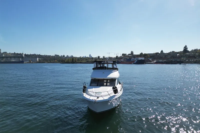 Gra-sea Yacht Photos Pics 2005 Meridian 381 Sedan yacht cruising on a sunny day in a scenic harbor.