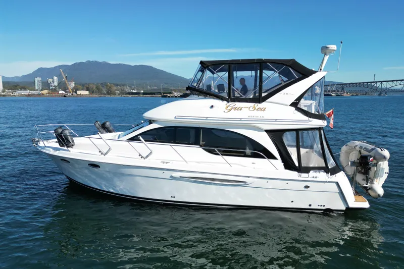 Gra-sea Yacht Photos Pics 2005 Meridian 381 Sedan yacht on water with scenic mountain and city backdrop.