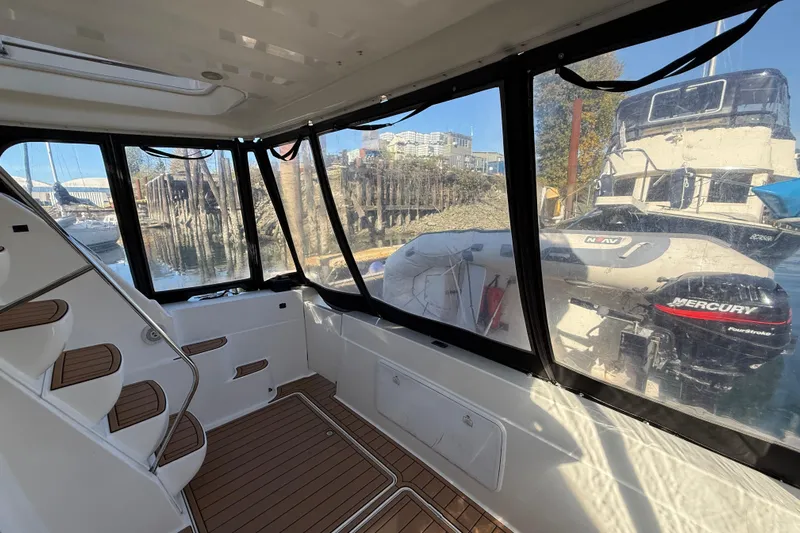 Gra-sea Yacht Photos Pics Interior view of a 2005 Meridian 381 Sedan boat with docked inflatable boat outside.