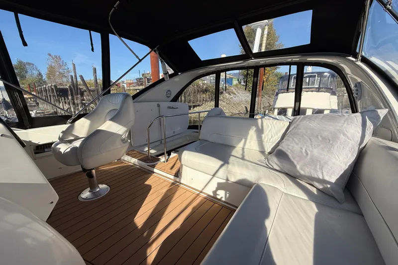 Gra-sea Yacht Photos Pics Interior of 2005 Meridian 381 Sedan yacht with white seating and wooden flooring.