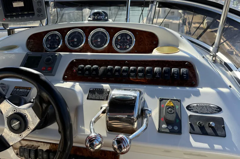 Gra-sea Yacht Photos Pics Control panel of a 2005 Meridian 381 Sedan boat with steering wheel and gauges.