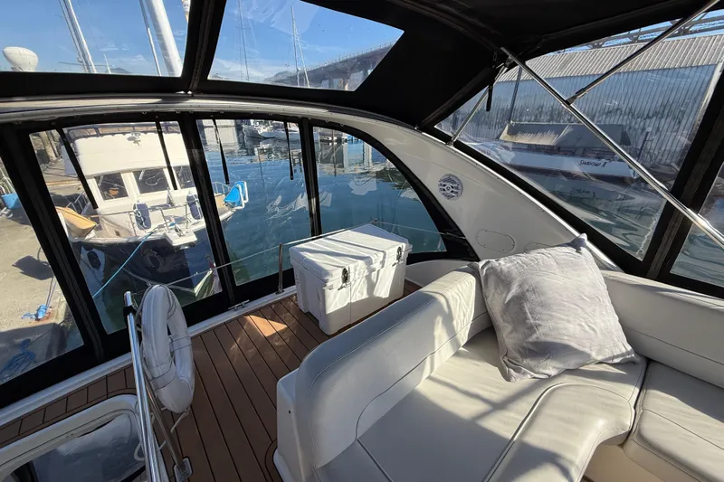 Gra-sea Yacht Photos Pics Interior view of 2005 Meridian 381 Sedan yacht with seating and marina backdrop.