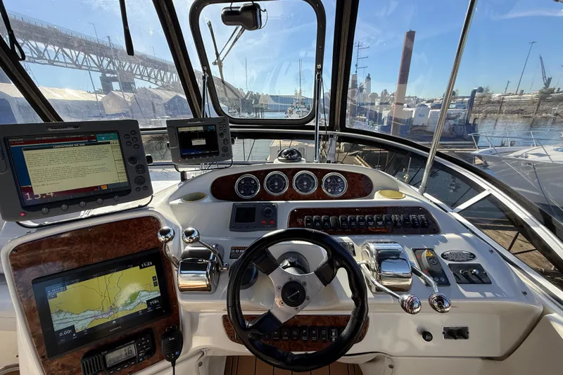 Gra-sea Yacht Photos Pics Helm of 2005 Meridian 381 Sedan with navigation equipment and scenic marina view.