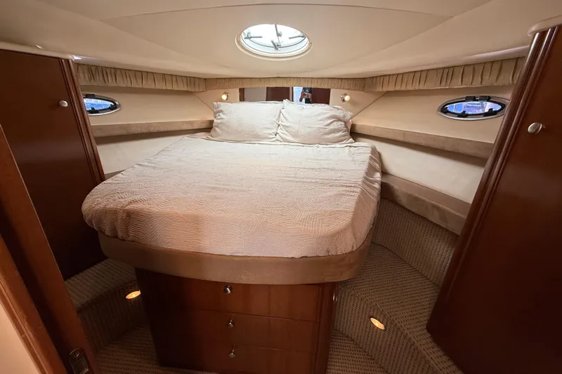 Gra-sea Yacht Photos Pics Luxurious cabin interior of 2005 Meridian 381 Sedan yacht with cozy bed and elegant wood finish.