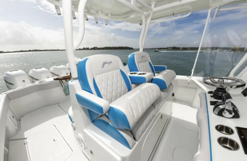  Yacht Photos Pics 2018 Yellowfin 39 boat interior with blue and white seating, ocean view in background.