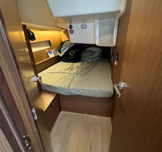 Odyssey Yacht Photos Pics Cozy cabin interior of 2021 Beneteau Oceanis 40.1 sailboat with bed and storage.