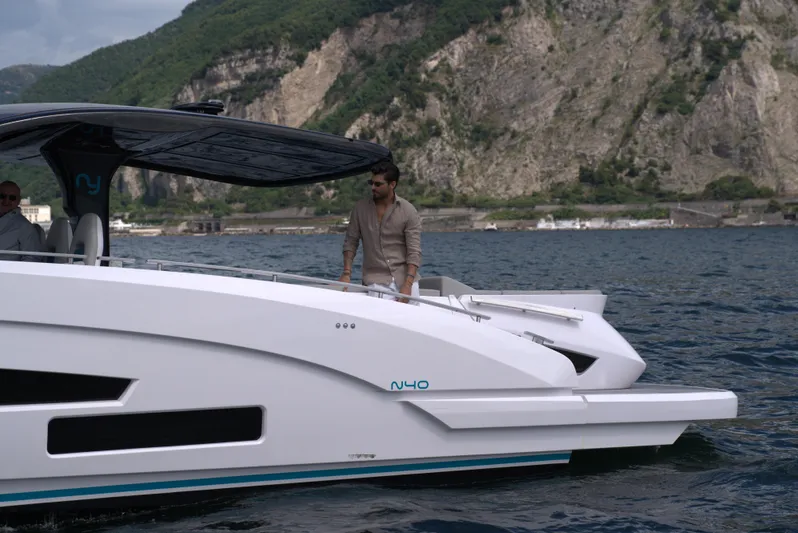  Yacht Photos Pics Modern Nassima Yacht N40 (2025) cruising on a scenic lake with mountainous backdrop.