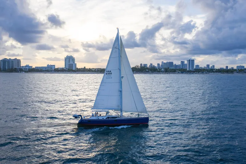 Blue Star Yacht Photos Pics Sailing yacht Hylas 63, 2013 model, cruising near city skyline at sunset.
