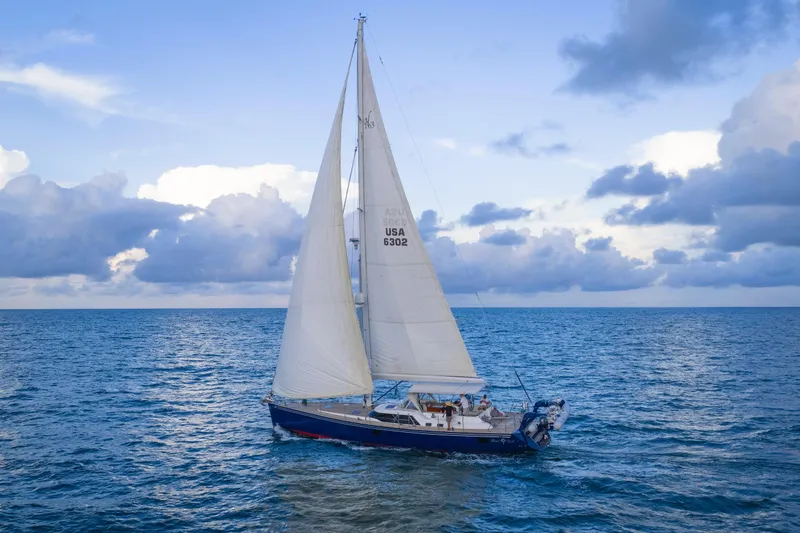 Blue Star Yacht Photos Pics Sailing yacht Hylas 63 (2013) gliding on open sea under a cloudy sky.