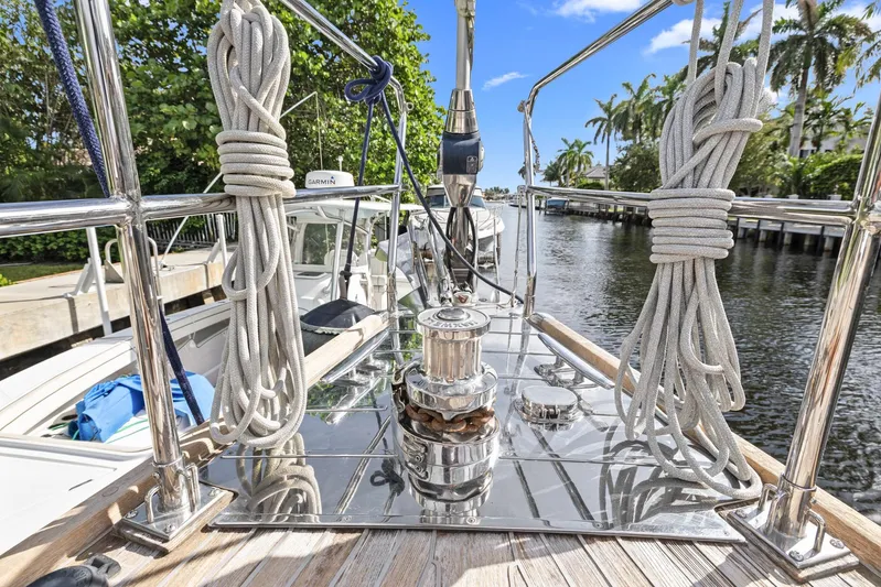 Blue Star Yacht Photos Pics Deck view of 2013 Hylas 63 yacht with ropes and winch, docked by palm trees.