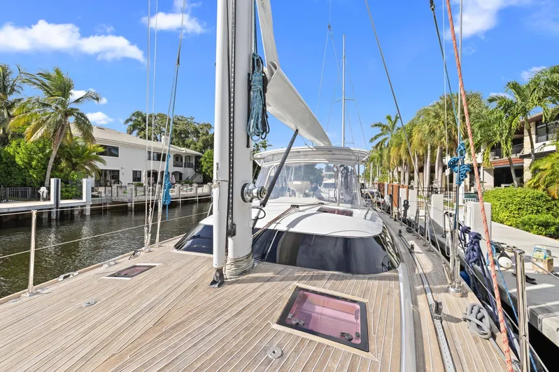 Blue Star Yacht Photos Pics Sailing yacht Hylas 63, 2013 model, docked by palm trees and waterfront homes.
