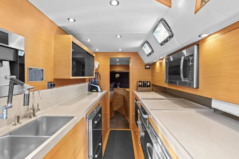 Blue Star Yacht Photos Pics Luxurious galley kitchen in a 2013 Hylas 63 yacht, featuring modern appliances and sleek design.