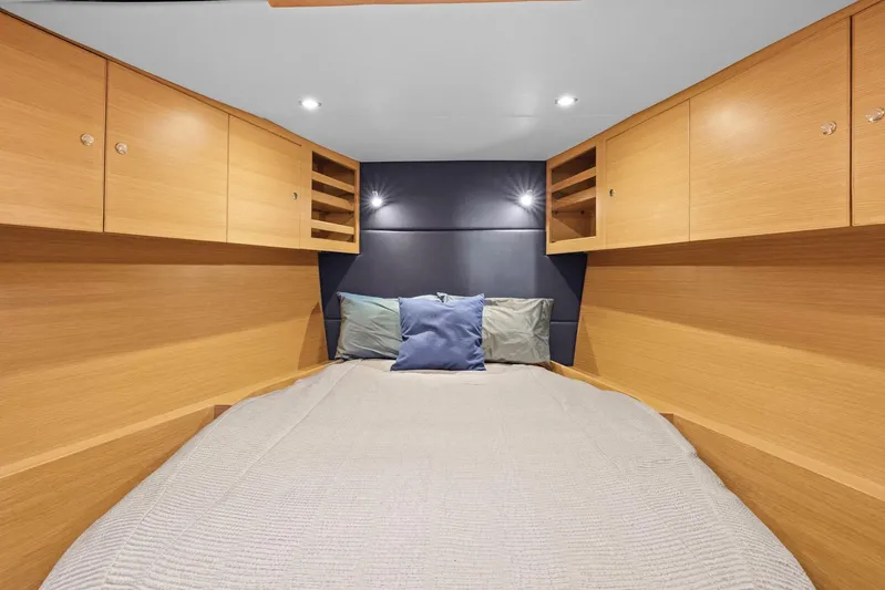 Blue Star Yacht Photos Pics Luxurious cabin interior of 2013 Hylas 63 yacht with cozy bedding and wooden cabinetry.