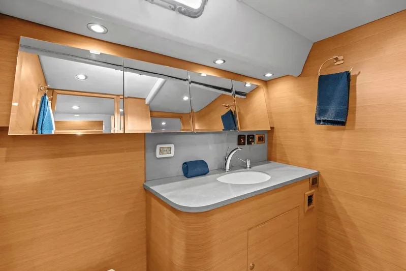 Blue Star Yacht Photos Pics Luxurious bathroom interior of 2013 Hylas 63 yacht with modern fixtures and wooden finish.