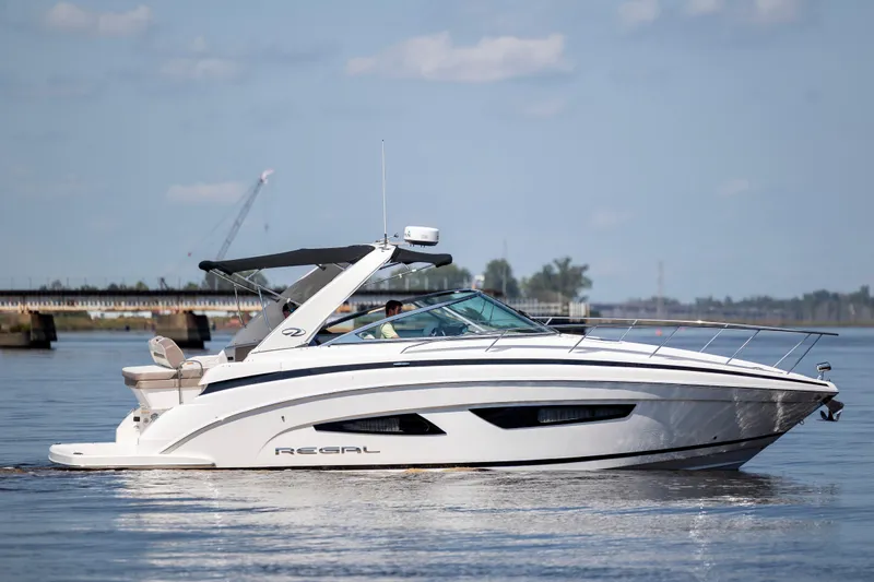  Yacht Photos Pics 2017 Regal 32 Express boat cruising on calm water under a clear sky.