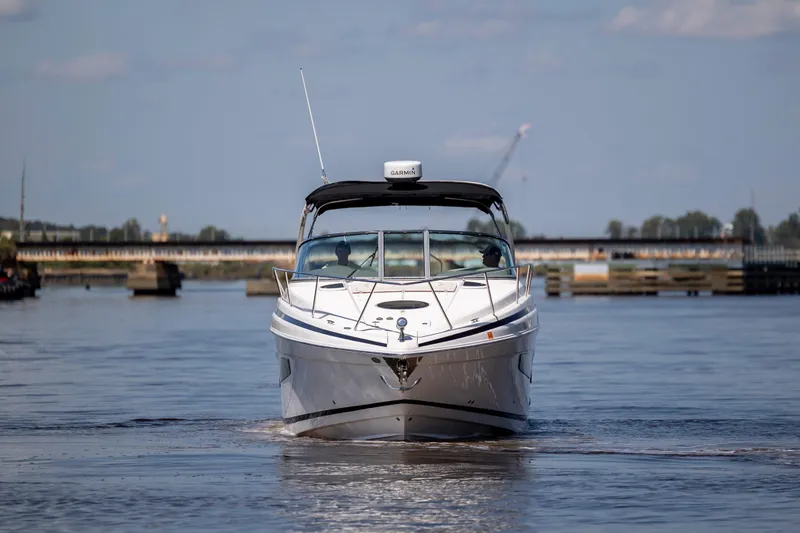  Yacht Photos Pics 2017 Regal 32 Express boat cruising on a calm river under a clear sky.
