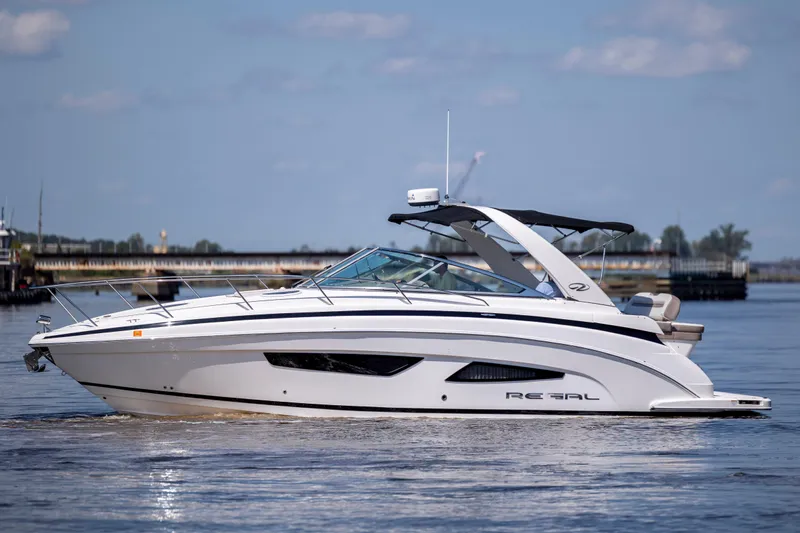  Yacht Photos Pics 2017 Regal 32 Express boat cruising on calm water under a clear sky.