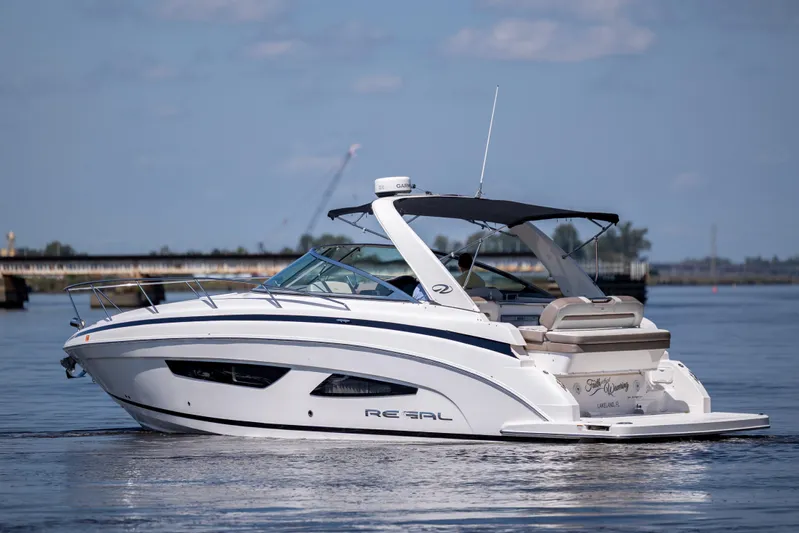  Yacht Photos Pics 2017 Regal 32 Express boat cruising on calm waters under a clear sky.
